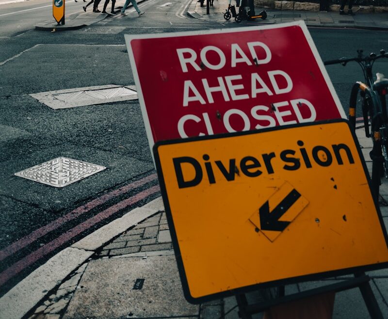 a road ahead closed sign on the side of the road